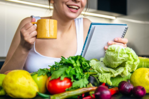 young woman kitchen with notebook among vegetables 169016 24384